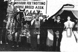 The 1986 World Champion Missouri Fox Trotter is Madam Sensation; owned by Spencer (Pop) Jenkins (fourth from right), Sedalia, Mo., and ridden to victory Saturday night by Geno Middleton, Nixa, Mo. Presenting the Charlotte Dampier Memorial Trophy to  Jenkins is Dale Esther, president of the Missouri Fox Trotting Horse Breed Association.